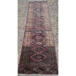 An old Afghan washed red ground runner, 281 cm x 76 cm
