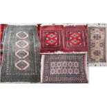 A Teke Bokhara geometric design pink ground rug 131 cm x 78 cm to/with a pair of Turkoman style