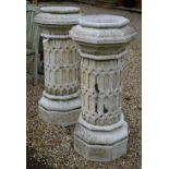 A pair of sectional reconstituted sandstone garden planters on plinths in the form of Victorian