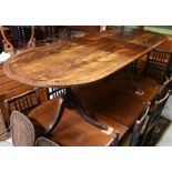 A Victorian style D-end mahogany twin pedestal dining table with extension leaf, on carved paw feet