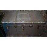 A vintage rivetted aluminium flight trunk with leather handles and fabric lined interior