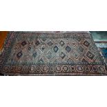 An old worn Persian Baluch, arrangement of diamond medallions on brown ground, rosette border, 214 x