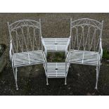 A cream painted steel companion seating set united by a table