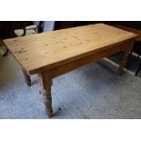 A pine kitchen table raised on turned legs, 183 x 84 x 79 cm h