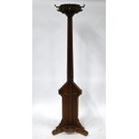 An Arts & Crafts period oak hall stand with brass hooks and stick/umbrella retaining brackets, on