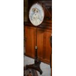 A Regency rosewood pole screen, the adjustable rise and fall pole with needlepoint panel on a