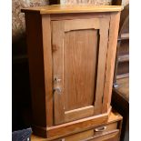 An old pine floor standing corner cupboard