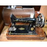 A vintage cased Singer hand sewing machine