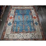 A Turkish Milas rug, abrashed sky-blue ground with symmetrical tree design with geometric cream