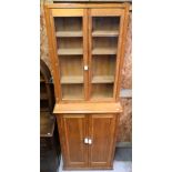 A pine cupboard 73 cm x 31 cm x 108 cm h to/w a glazed-in pine cabinet 68 cm x 17 cm x 98 cm h (2)