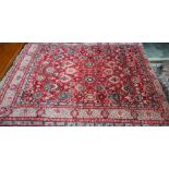 A small Persian carpet, arrangemtn of rosettes and palmettes on ruby red ground, floral cream