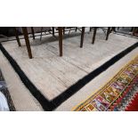 Large wool carpet, champagne ground with multi coloured irregular striations, dark brown narrow