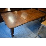 A Victorian oak extending (wind action) dining table, the moulded edge with two leaves (slightly