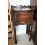 A small mahogany pot cupboard with galleried top, panelled door and slender supports, 38 cm wide x