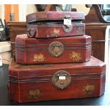 A set of three graduated Chinese scene-painted trinket boxes with brass mounts, lined with printed