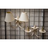 Two cream-painted metal twin-sconce wall lights with star motif