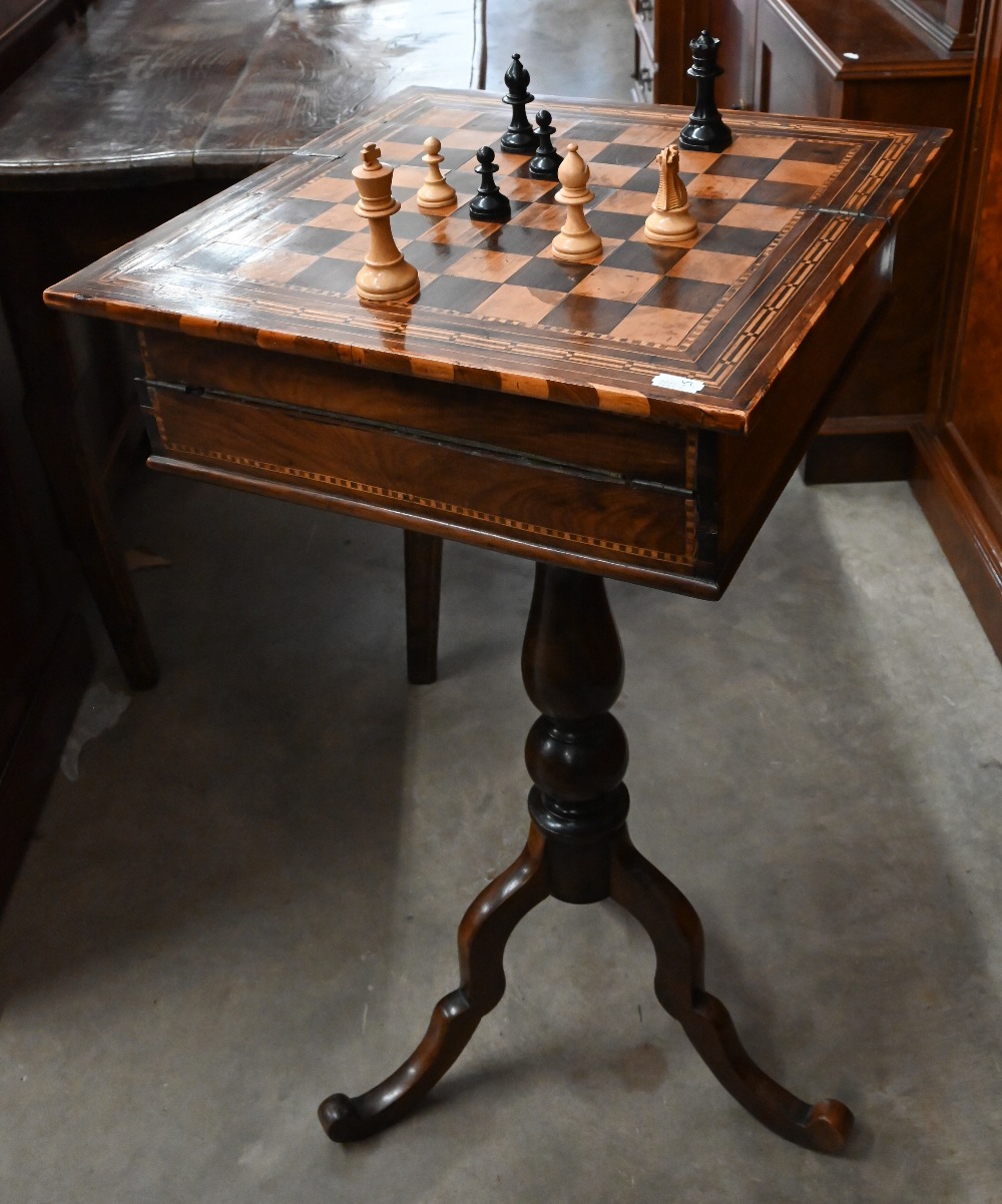 An Edwardian marquetry games/sewing table with chess board inlaid top enclosing fitted interior on