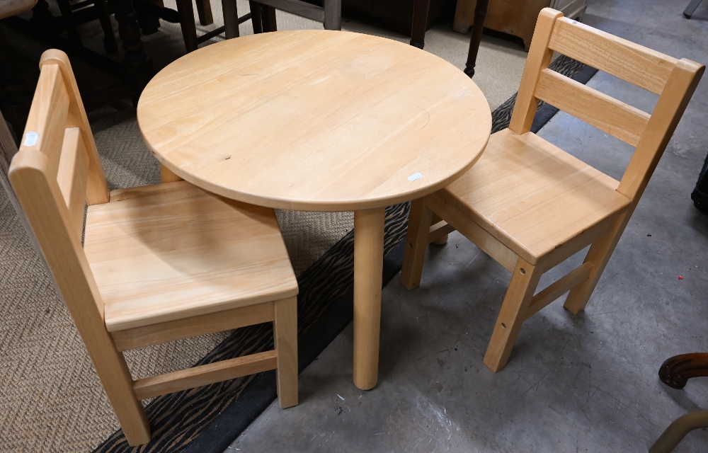 A beech children's dining set comprising circular table, 60 cm diam x 42 cm high to/w two chairs