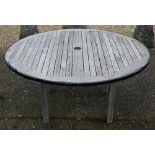 A Barlow Tyrie weathered teak circular table