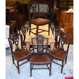 A set of seven Georgian style Hepplewhite mahogany dining side chairs with crimson fabric seat