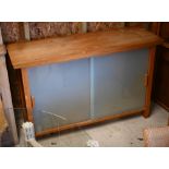 A contemporary solid golden oak sideboard with tapering leg over pair of sliding frosted glass doors