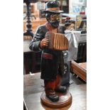 Carved and painted wood figure of a street musician with monkey and accordion, 64 cm