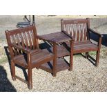 A weathered stained teak conversation seat / table, c/w cover