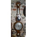 A 19th century mahogany wheel barometer with silvered dial, thermometer, level centred by a convex