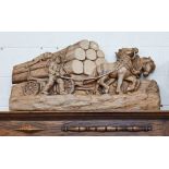 Carved wood relief depicting woodsman with horsedrawn wagon loaded with tree trunks, 56 x 106 cm