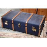 A school pattern blue travelling trunk with wooden runners