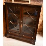 A Victorian style low mahogany astragal glazed bookcase, two drawers below on shaped bracket feet