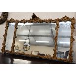 A triple plate wall mirror with giltwood and gesso floral moulded frame, 112 cm wide x 64 cm high