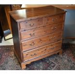 A contemporary stained pine chest of two short over three long graduated drawers on shaped bracket