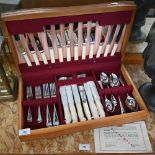 A canteen of chrome plated flatware and cutlery - apparently unused (knife handles not ivory)