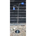 A chrome floor-lamp with twin adjustable lights