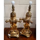 Pair of gilded resin heraldic rampant lion table lamps, 38 cm high