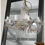 A brass and glass eight branch electrolier/chandelier hung with faceted glass drops