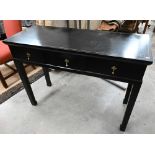 A black framed console table with gilt detailing, three drawers and square supports