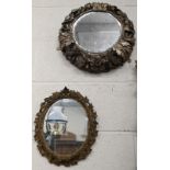 A small antique ovall wall mirror in floral and foliate giltwood and gesso frame, 34 cm high x 28 cm