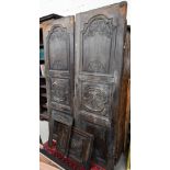 A pair of antique carved oak armoire doors with armorial devices a/f