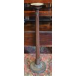 A 19th century mahogany jardiniere stand, converted from a carved bed post, weighted base
