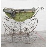 An antique baby's pram with painted body, china handle and wrought iron frame