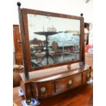A 19th century mahogany framed toilet mirror on three drawer platform base with lion mask brass
