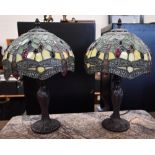 A pair of Tiffany style table lamps with stained glass shades in the Art Nouveau manner, 40 cm high