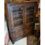 A part glazed Old Charm style carved oak cabinet with linenfold design, 98 cm wide x 33 cm deep x