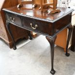 A mahogany bow front two drawer serving table with piecrust moulded top and shell carved cabrioe