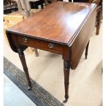 A 19th century mahogany Pembroke table with turned supports and small casters