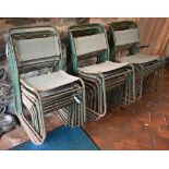 Twenty mid-century stacking utility chairs, weathered green steel frames with canvas seats/backs -