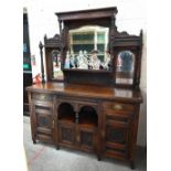 An Art Nouveau carved walnut mirror-backed sideboard, 152 cm wide x 52 cm deep x 198 cm high