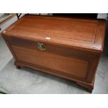 A Chinese hardwood and brass mounted blanket chest of panelled construction with camphor lined